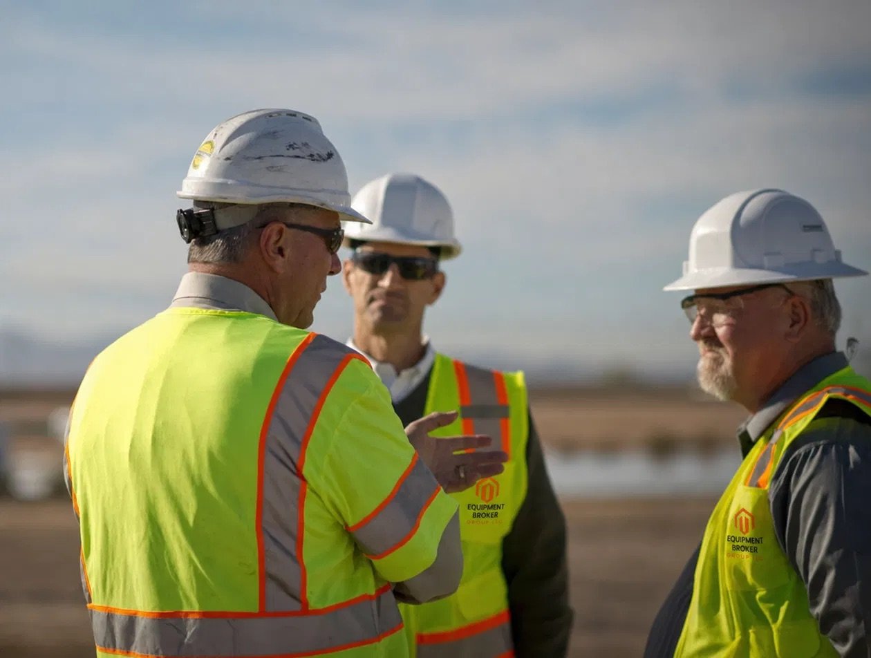 Equipment Broker Group team reviewing equipment on a jobsite